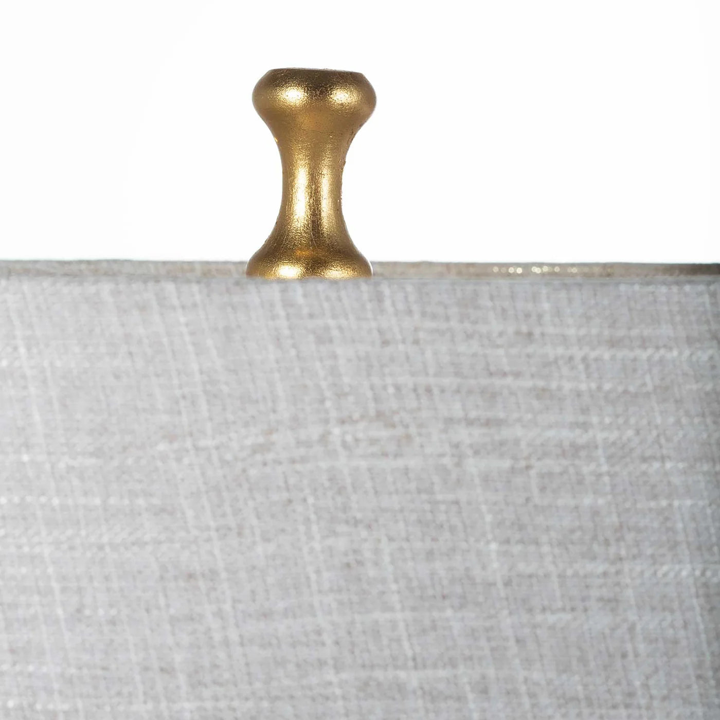 Detail of the Adèle Table Lamp linen shade with visible woven texture and a small warm-gold finial at the top.