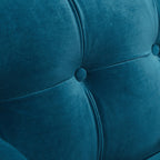 Macro texture detail of the Cadence sofa backrest, showcasing a flawless button-tufted square grid pattern in soft, plush teal blue velvet fabric.