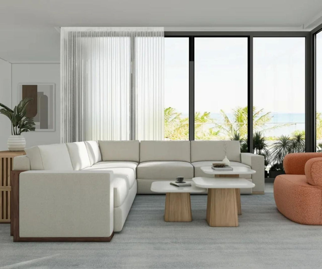 Portico Travertine Accent Table shown in a styled interior, highlighting the honed pale stone top and warm sienna pedestal base.