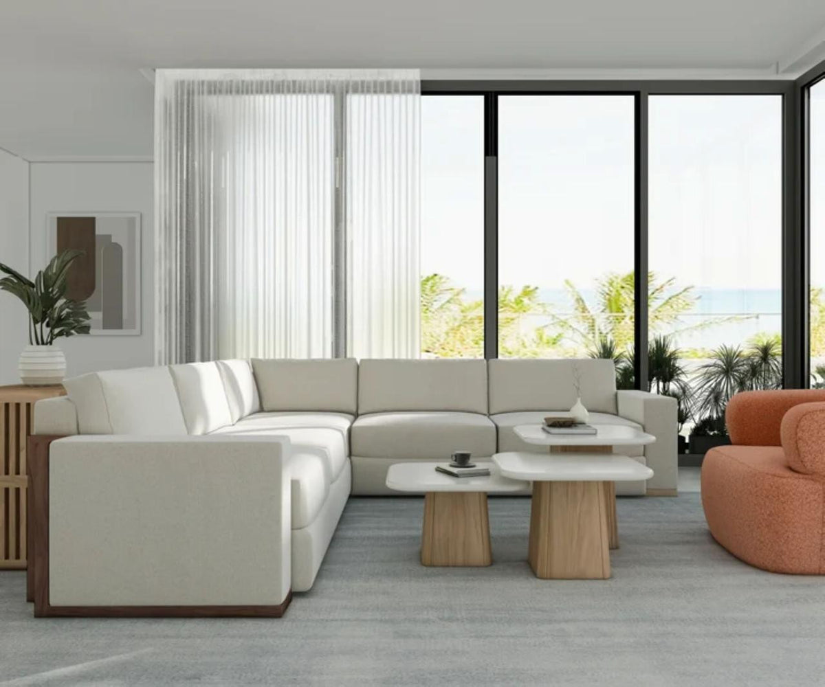Portico Travertine Accent Table shown in a styled interior, highlighting the honed pale stone top and warm sienna pedestal base.