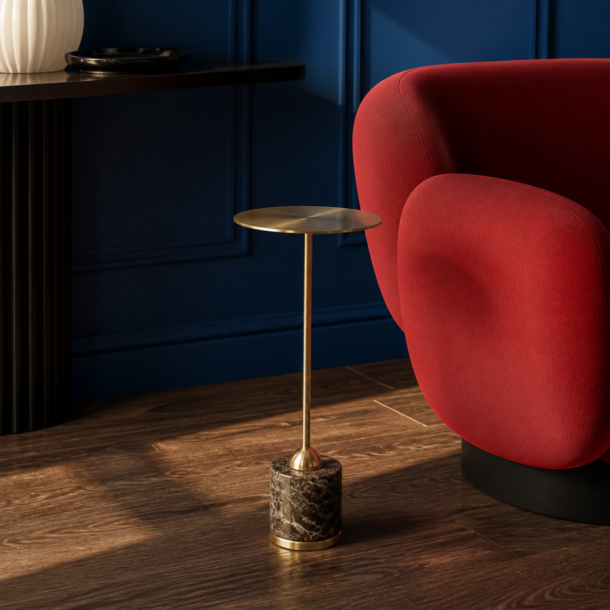 The Isabeau Drink Table beside a red lounge chair against sapphire-blue walls