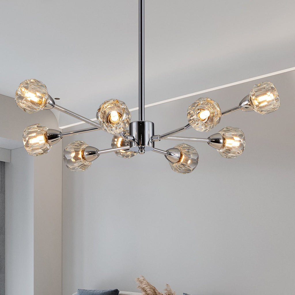 Editorial lifestyle shot of the Polaris 9-light chandelier in polished chrome, showcasing its linear sputnik frame structure and illuminated faceted crystal glass globes.