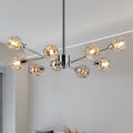 Editorial lifestyle shot of the Polaris 9-light chandelier in polished chrome, showcasing its linear sputnik frame structure and illuminated faceted crystal glass globes.
