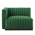 Clean three-quarter studio presentation of the Velvet Rogue emerald green velvet loveseat, highlighting the continuous vertical channel tufting and the hidden black plinth base against a white backdrop.